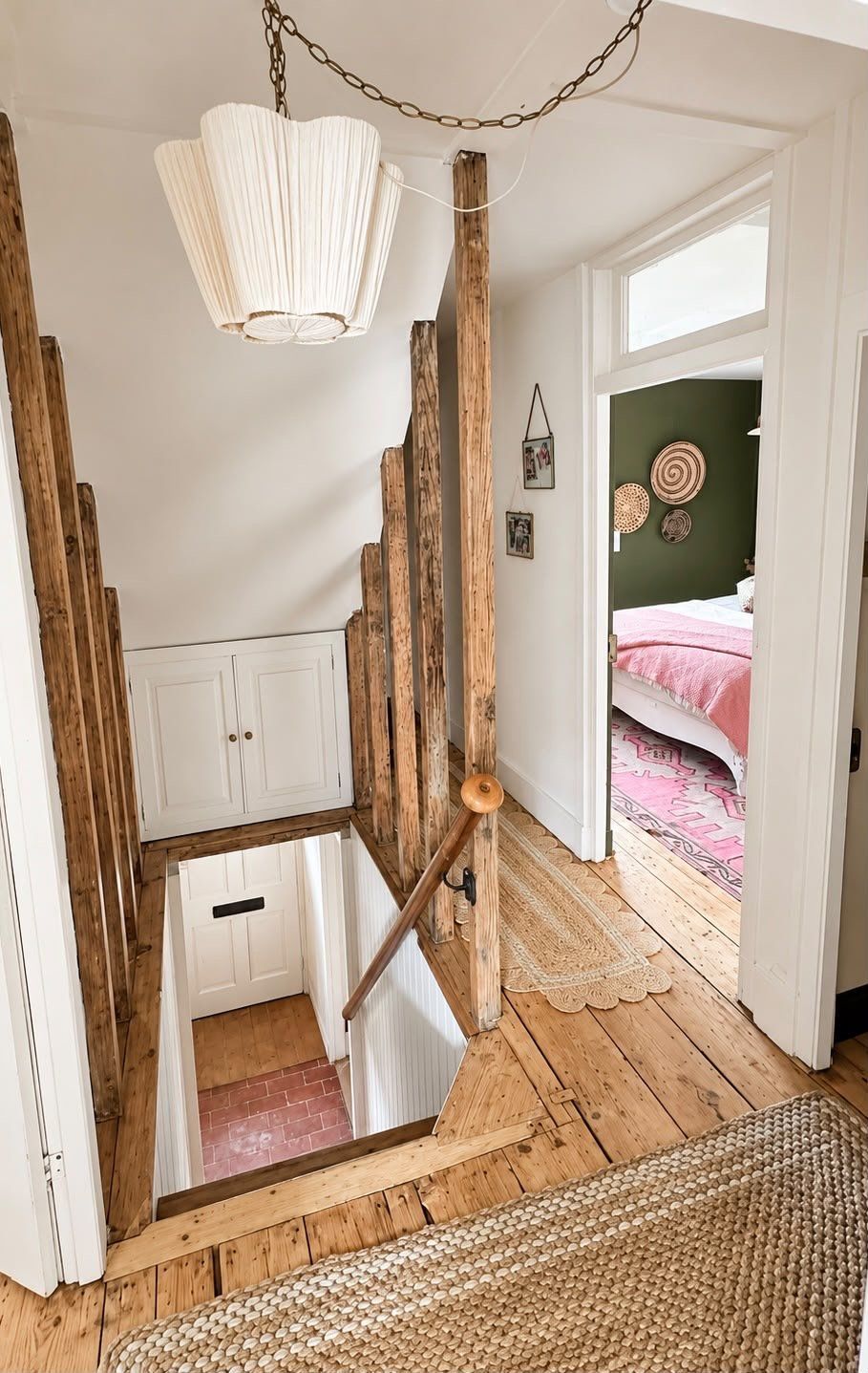 The staircase, framed by old timbers, rising to a landing
